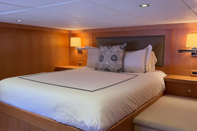 Slide: The Image of Luxurious bedroom interior on 2011 Pedigree Cat Sportfish Catamaran with elegant bedding and warm lighting. - 60
