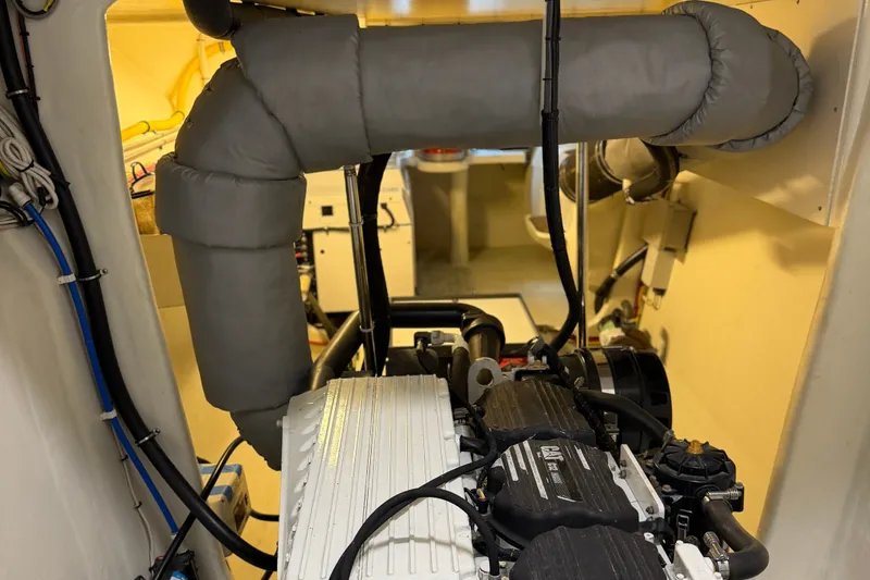 Slide: The Image of Engine room of a 2011 Pedigree Cat Sportfish Catamaran, showcasing mechanical components. - 69