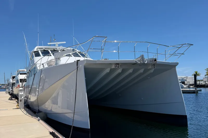 Slide: The Image of 2011 Pedigree Cat Sportfish Catamaran docked at marina under clear blue sky. - 3