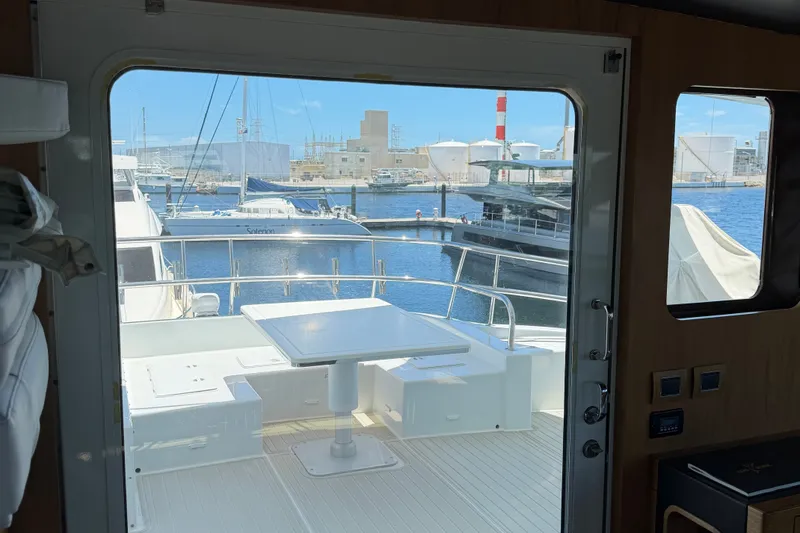 Slide: The Image of Interior view of 2011 Pedigree Cat Sportfish Catamaran overlooking marina with boats. - 13