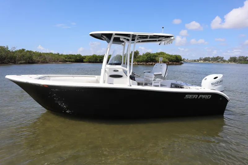 The Image of 2021 Seapro 219 boat on calm water, featuring Suzuki engine, clear sky background. - 1