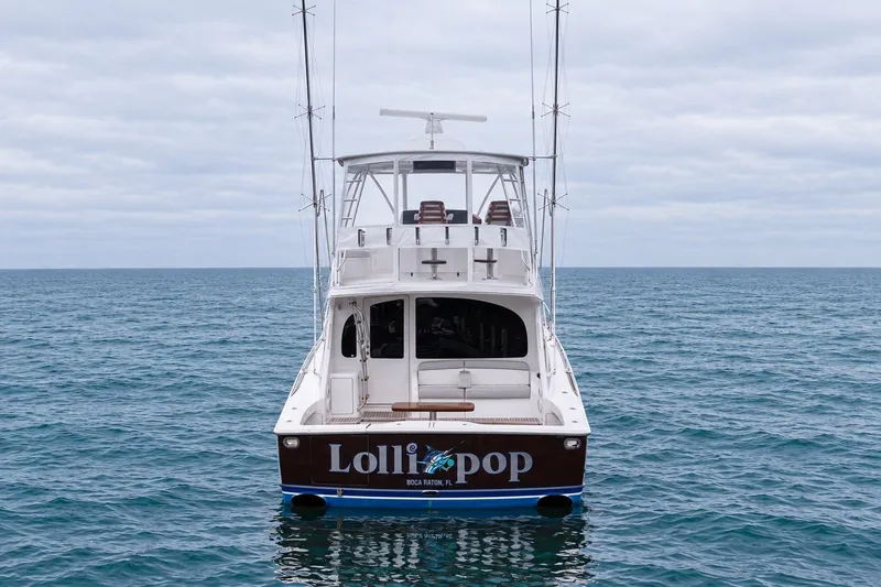 Slide: The Image of 2022 Viking 48 Convertible yacht on open sea, rear view. - 4