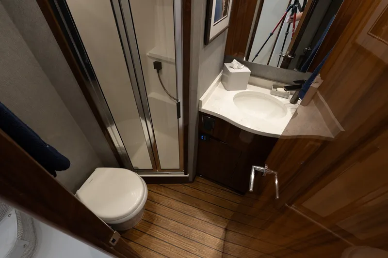 Slide: The Image of Bathroom interior of 2022 Viking 48 Convertible yacht with shower and sink. - 47