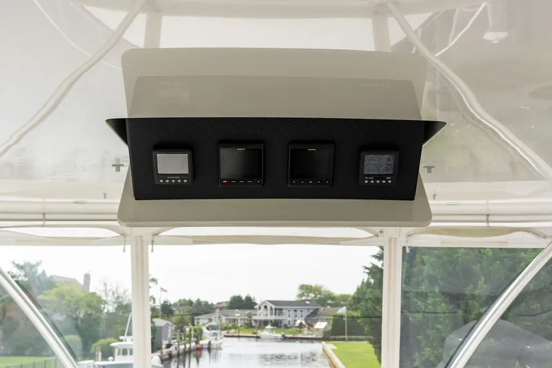 Slide: The Image of Control panel of 2022 Viking 48 Convertible yacht with scenic marina view. - 25