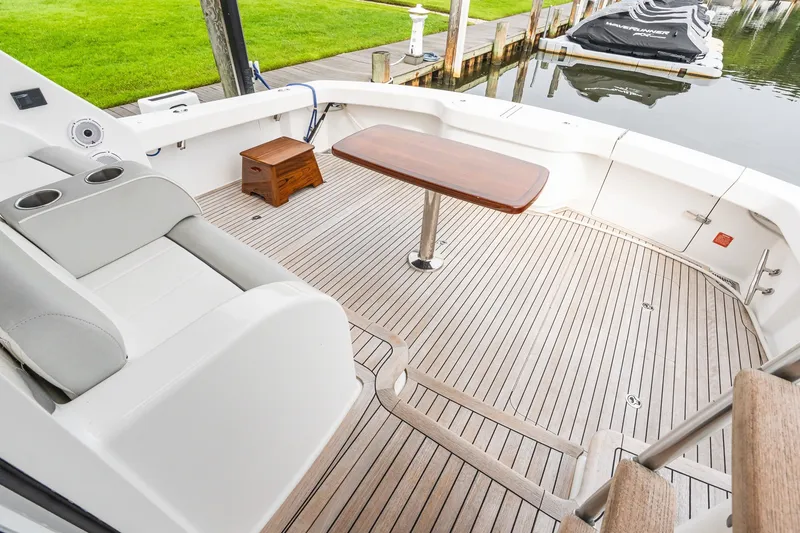 Slide: The Image of Luxurious deck of 2022 Viking 48 Convertible yacht with seating and table. - 12