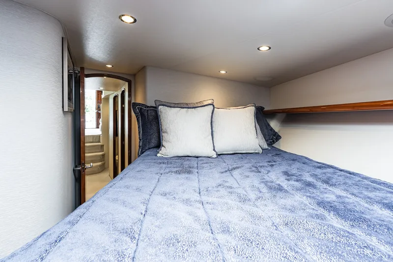 Slide: The Image of Luxurious cabin interior of 2022 Viking 48 Convertible yacht with plush bedding. - 48