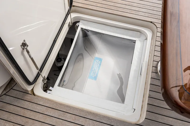 Slide: The Image of Open hatch on 2022 Viking 48 Convertible yacht, revealing storage compartment. - 11
