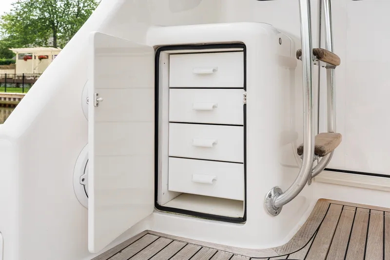 Slide: The Image of Open storage compartment with drawers on 2022 Viking 48 Convertible yacht deck. - 14