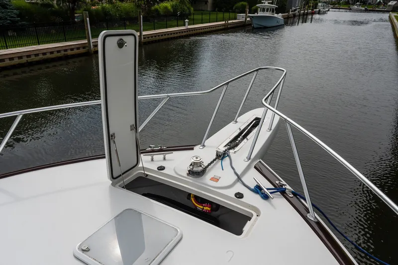 Slide: The Image of Bow of 2022 Viking 48 Convertible yacht with open hatch and railing. - 32