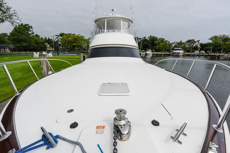 Slide: The Image of 2022 Viking 48 Convertible yacht docked, showcasing sleek design and spacious deck. - 33