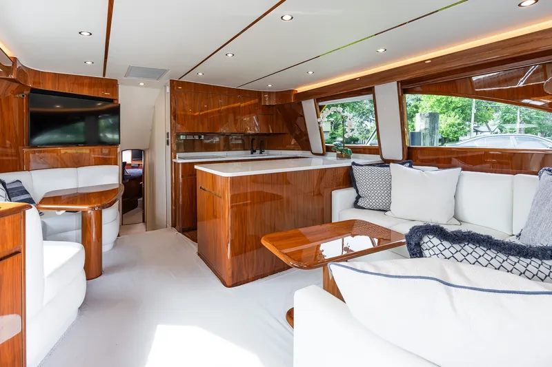Slide: The Image of Luxurious interior of 2022 Viking 48 Convertible yacht with elegant wood finishes and plush seating. - 34