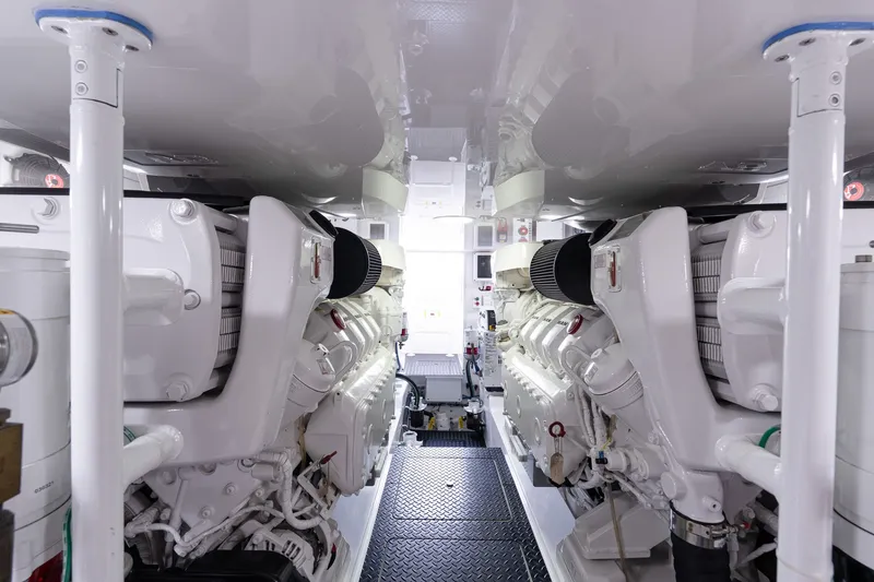 Slide: The Image of Engine room of 2022 Viking 48 Convertible yacht, showcasing dual engines and mechanical systems. - 54