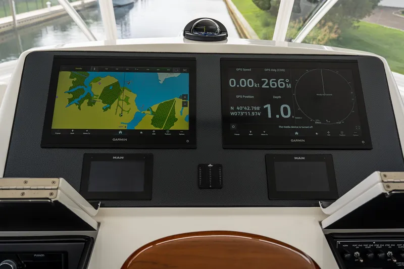 Slide: The Image of Bridge of 2022 Viking 48 Convertible yacht with Garmin navigation displays. - 22