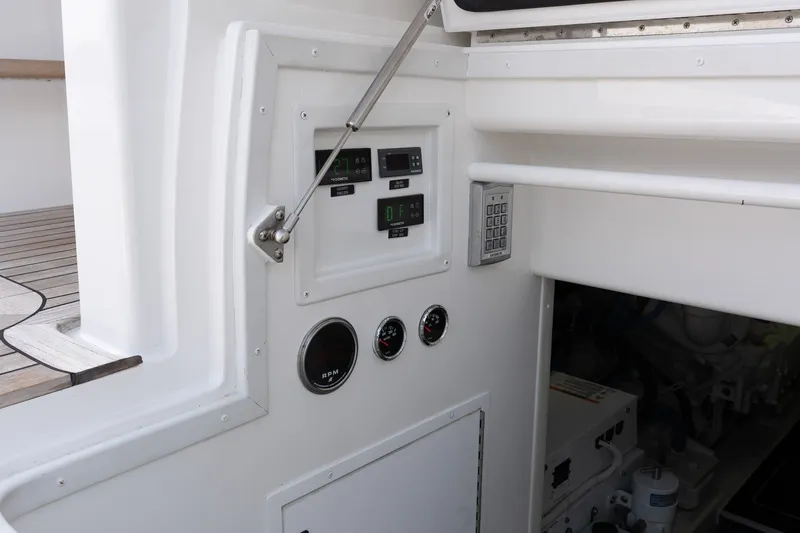 Slide: The Image of Control panel on a 2022 Viking 48 Convertible yacht, featuring gauges and keypad. - 57