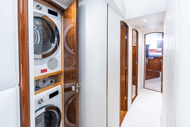 Slide: The Image of Laundry area in 2022 Viking 48 Convertible yacht with stacked washer and dryer. - 42