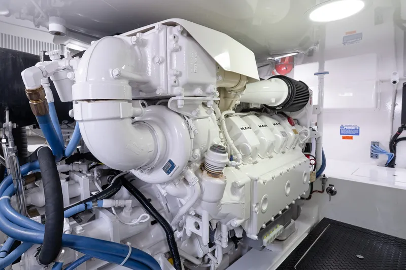 Slide: The Image of Engine room of 2022 Viking 48 Convertible yacht, showcasing a powerful marine engine. - 52