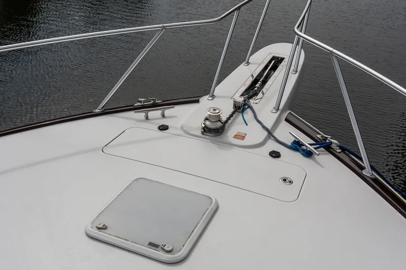 Slide: The Image of Bow of 2022 Viking 48 Convertible yacht with anchor and railing. - 31