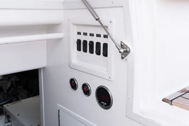 Slide: The Image of Control panel of 2022 Viking 48 Convertible yacht with switches and gauges. - 56