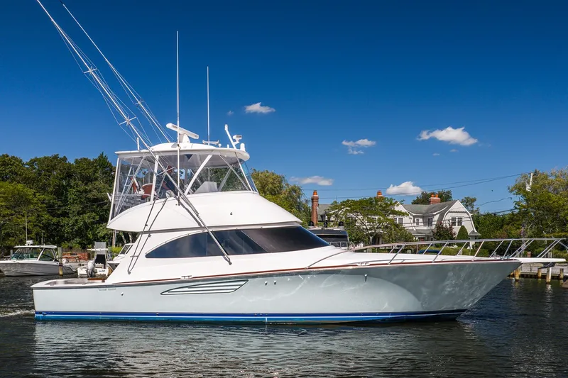 The Image of 2022 Viking 48 Convertible yacht docked under clear blue sky. - 0