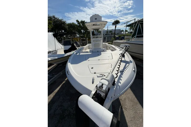 Slide: The Image of 2021 Caymas 28 HB boat with trolling motor, docked under a sunny sky. - 29