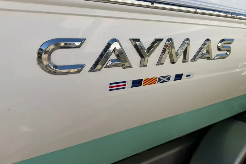 Slide: The Image of 2021 Caymas 28 HB boat logo with nautical flags on hull. - 31