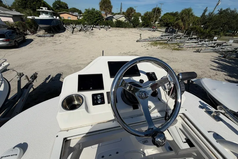 Slide: The Image of 2021 Caymas 28 HB boat helm with steering wheel and control panel. - 7