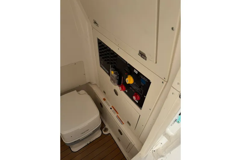 Slide: The Image of 2021 Caymas 28 HB boat interior with control panel and portable toilet. - 14