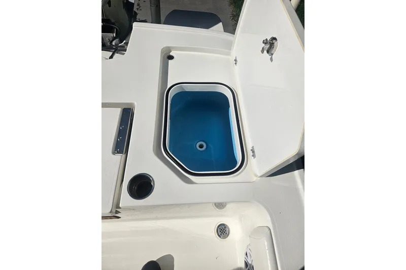Slide: The Image of Open storage compartment on 2021 Caymas 28 HB boat, featuring a blue interior. - 23