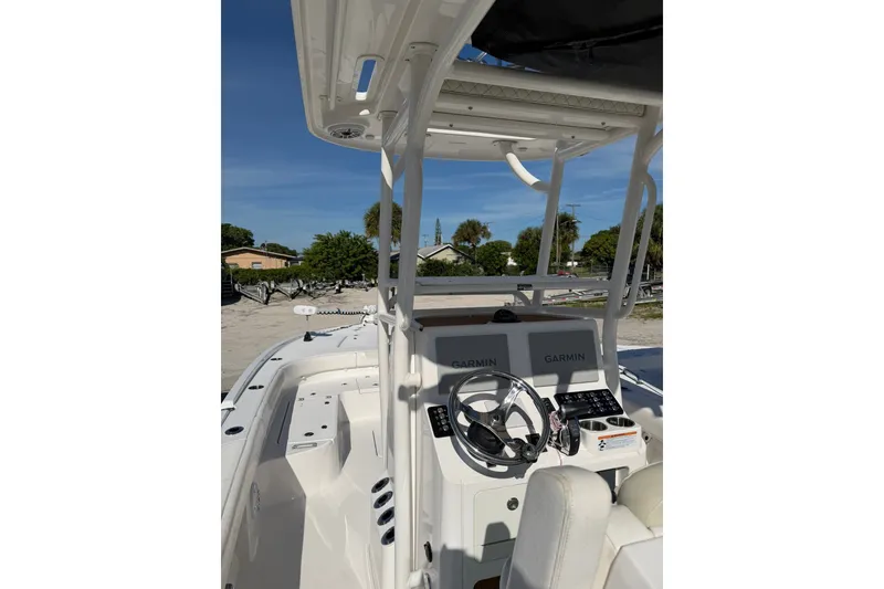 Slide: The Image of 2021 Caymas 28 HB boat cockpit with Garmin navigation system and steering wheel. - 4