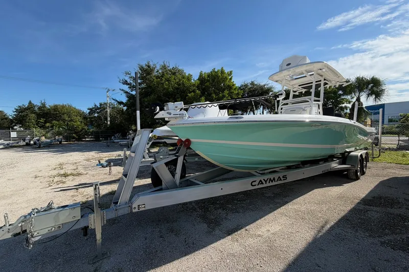 Slide: The Image of 2021 Caymas 28 HB boat on trailer, parked outdoors under clear blue sky. - 36