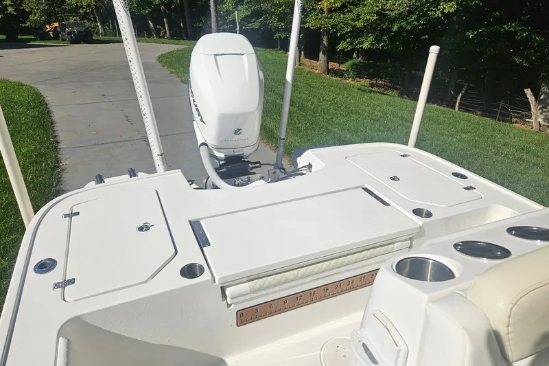 Slide: The Image of 2021 Caymas 28 HB boat with Mercury outboard motor, featuring spacious deck and cup holders. - 18