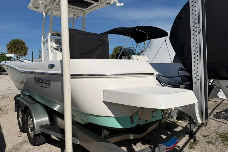 Slide: The Image of 2021 Caymas 28 HB boat on trailer, white hull, outdoor setting. - 28