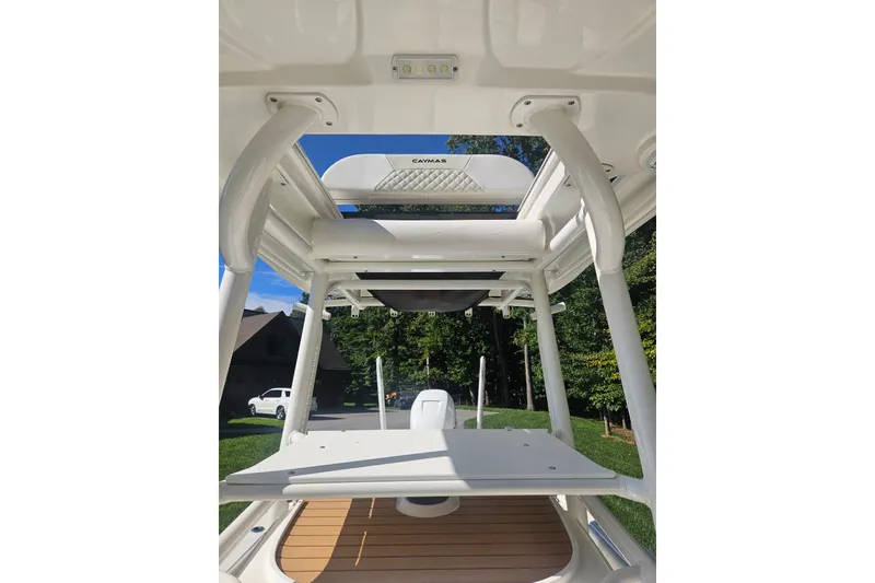Slide: The Image of 2021 Caymas 28 HB boat interior with white framework and wooden deck. - 5