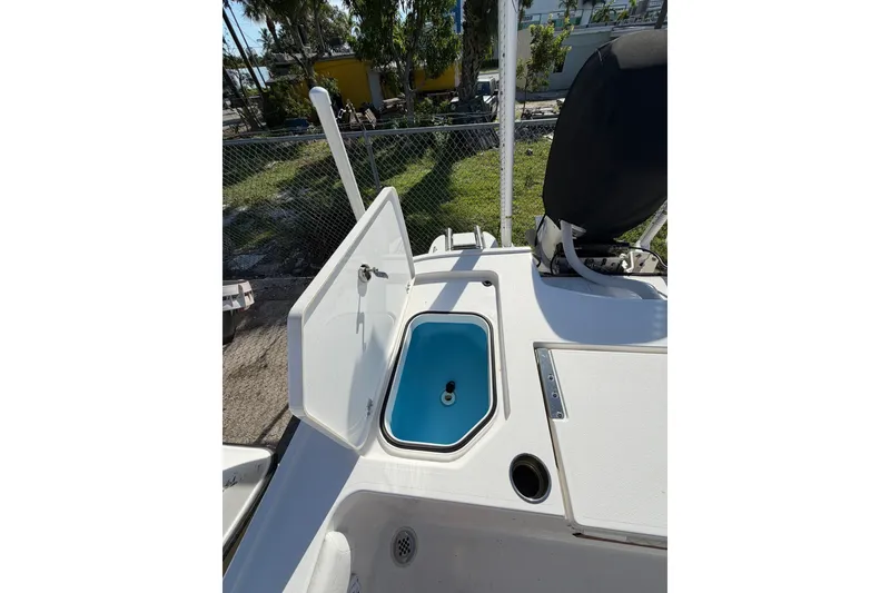 Slide: The Image of 2021 Caymas 28 HB boat with open storage compartment and blue interior. - 22