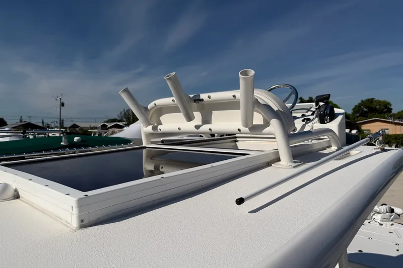 Slide: The Image of 2021 Caymas 28 HB boat deck with rod holders under clear blue sky. - 8