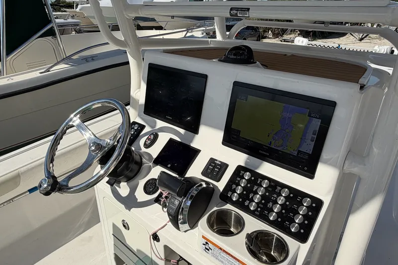 Slide: The Image of 2021 Caymas 28 HB boat dashboard with steering wheel and navigation screens. - 3
