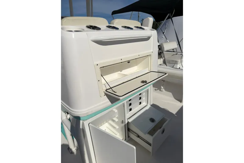 Slide: The Image of 2021 Caymas 28 HB boat interior with open storage compartments and seating. - 16