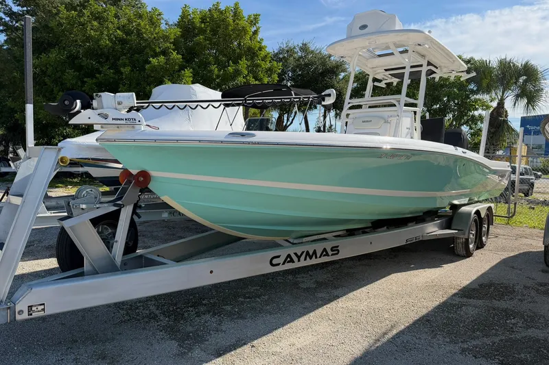 Slide: The Image of 2021 Caymas 28 HB boat on trailer, mint green hull, parked outdoors. - 35