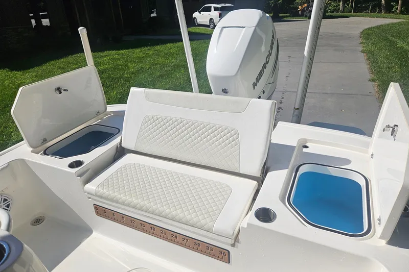 Slide: The Image of 2021 Caymas 28 HB boat interior with cushioned seating and storage compartments. - 20