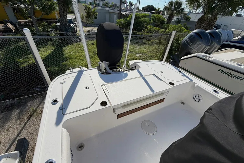Slide: The Image of 2021 Caymas 28 HB boat deck with storage compartments and engine cover. - 19