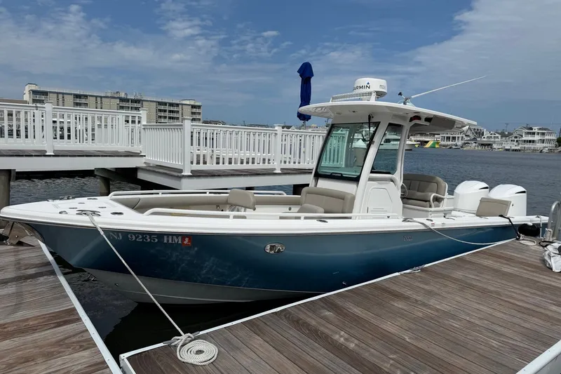 The Image of 2019 Everglades 273 Center Console boat docked at marina with clear sky. - 0