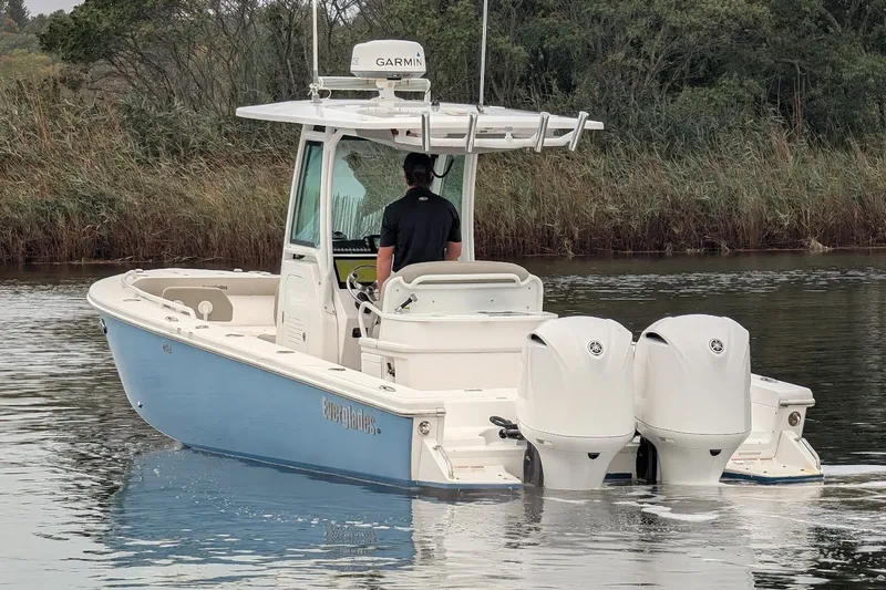 Slide: The Image of 2019 Everglades 273 Center Console boat on calm water, featuring dual engines. - 25