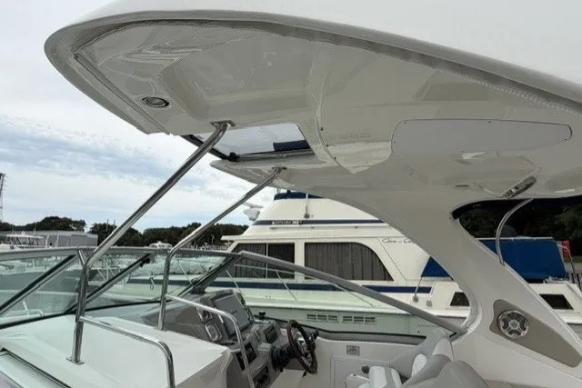 Slide: The Image of 2015 Chaparral 310 Signature boat cockpit with sleek design and modern controls. - 9