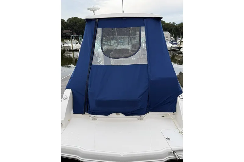 Slide: The Image of 2015 Chaparral 310 Signature boat with blue canvas cover at marina. - 14