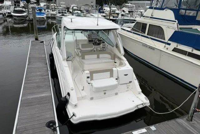 Slide: The Image of 2015 Chaparral 310 Signature boat docked at marina, rear view. - 6