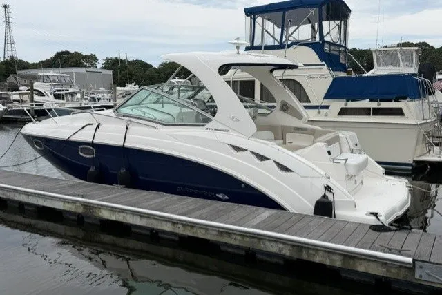 Slide: The Image of 2015 Chaparral 310 Signature boat docked at marina, side view. - 1