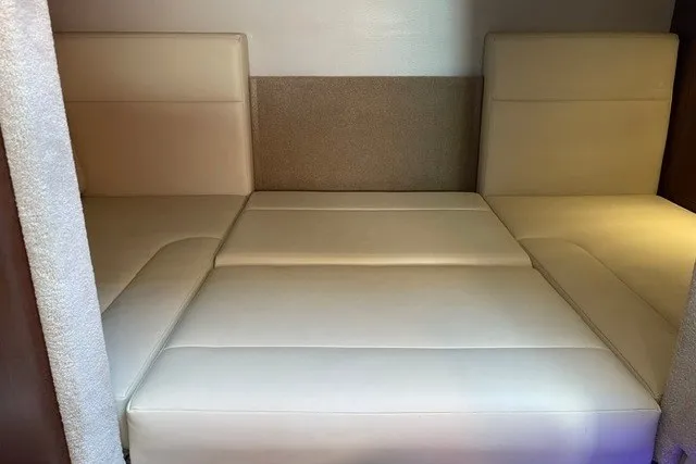 Slide: The Image of 2015 Chaparral 310 Signature interior with beige leather seating. - 22
