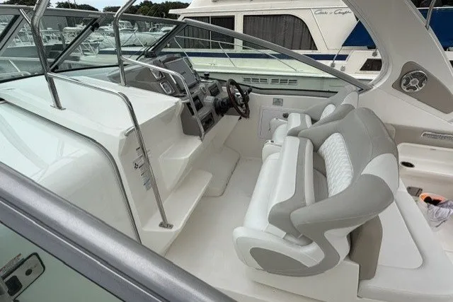 Slide: The Image of 2015 Chaparral 310 Signature boat interior with modern helm and comfortable seating. - 10