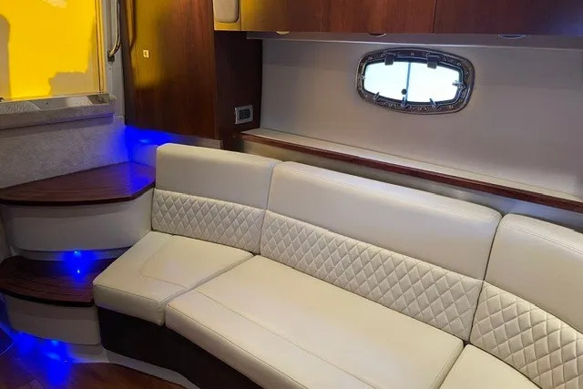 Slide: The Image of Interior of 2015 Chaparral 310 Signature yacht with elegant seating and ambient lighting. - 17