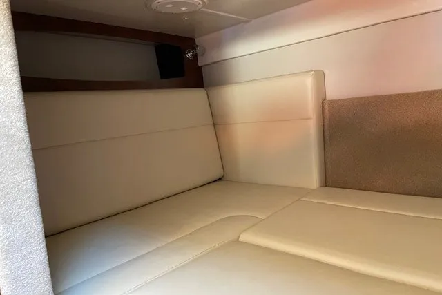 Slide: The Image of Interior cabin of 2015 Chaparral 310 Signature with beige seating and modern design. - 18